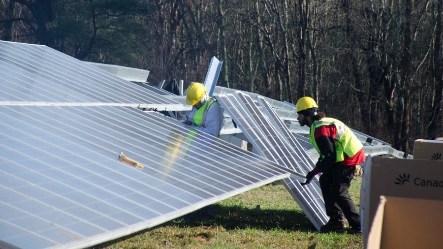 Workers are installing 3,500 solar panels in a field in Fairhaven, a town about 60 miles south of Boston. 