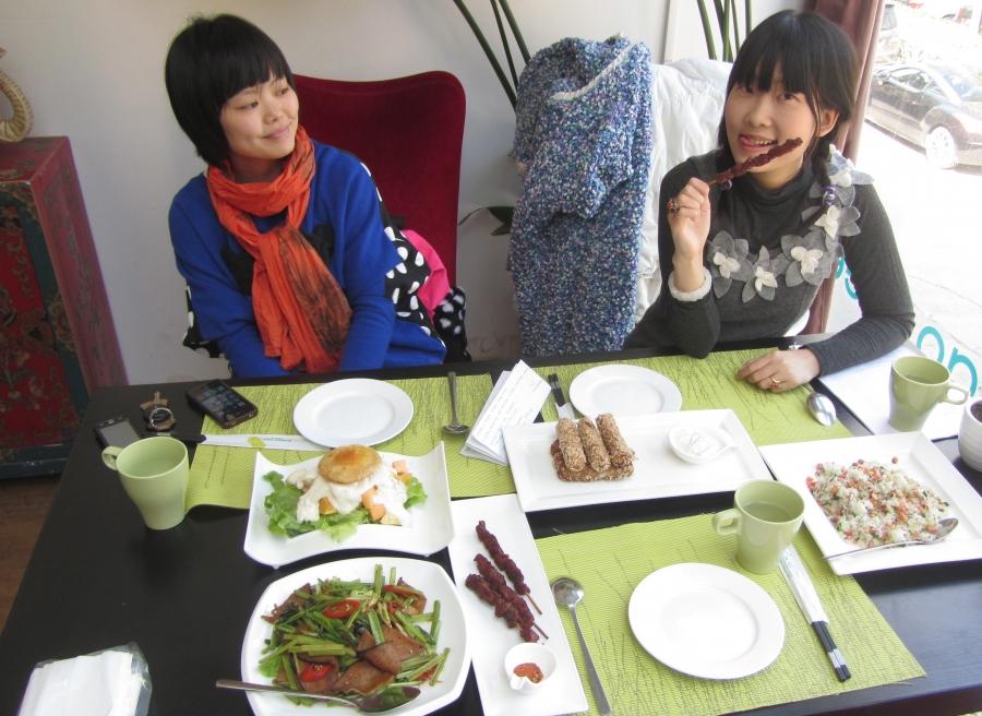 Vegan activist and singer Long Kuan and a friend enjoy meatless "lamb" kabobs at a Beijing restaurant.