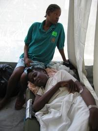 Nathalie LeBrun, in cot with niece Metalienne Anestal. She was a patient at HHS-Gheskio field hospital in Port-au-Prince.
