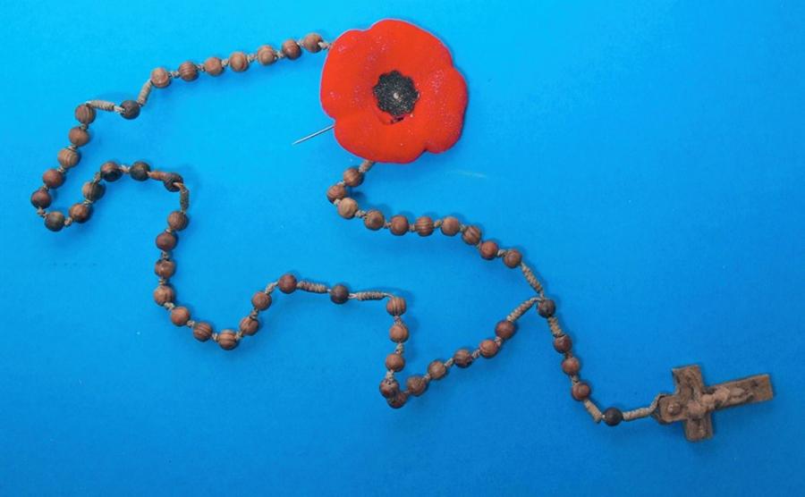 Rosary beads and a poppy found in the underground chamber.