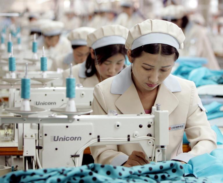  North Korea has an established textile industry. Here, North Korean workers stitch clothes for a South Korean brand in Kaesong industrial zone, May 2005.