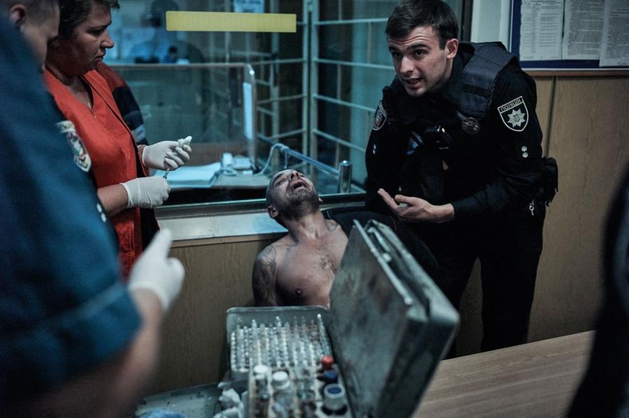 Lt. Vlad Fisotchenko helps paramedics calm down an aggressive intoxicated drug user.