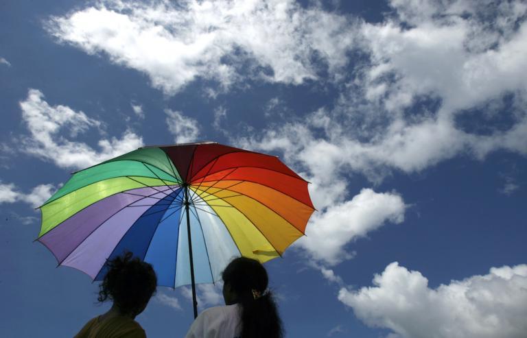 Under a rainbow umbrella in Dili, East Timor.