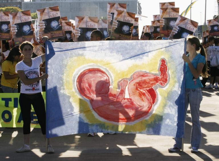 Demonstrators hold a banner during an anti-abortion march in Brasilia Sept. 10, 2008.