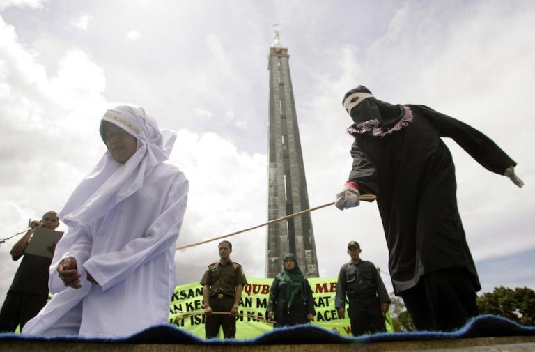 An Acehnese woman is caned for selling food during the Ramadan fast. In Aceh, anyone caught having a same-sex relationship faces the same fate.