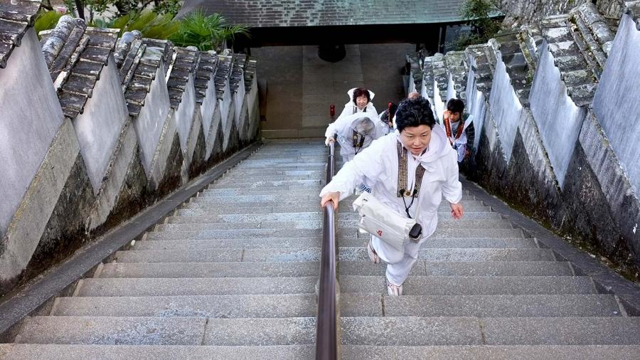 Pilgrims climb the steps to one of the 88 temples of the Shikoku pilgrimage in Japan.
