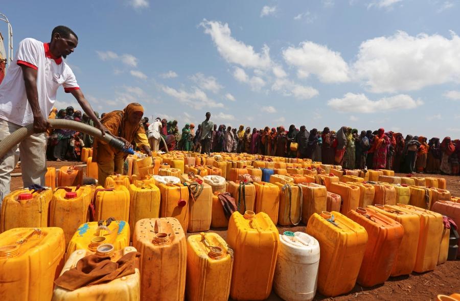 Internally displaced Somali women gather with their jerrycans to receive water at a distribution center after fleeing from drought-stricken regions in Baidoa, west of Somalia's capital Mogadishu, April 9, 2017.
