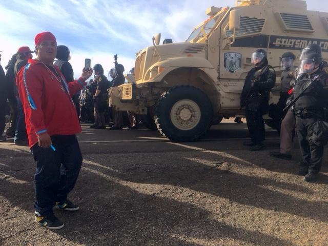 Protesters face off with law enforcement officers on a highway at the contested pipeline construction site near the Standing Rock Reservation and the Missouri River.