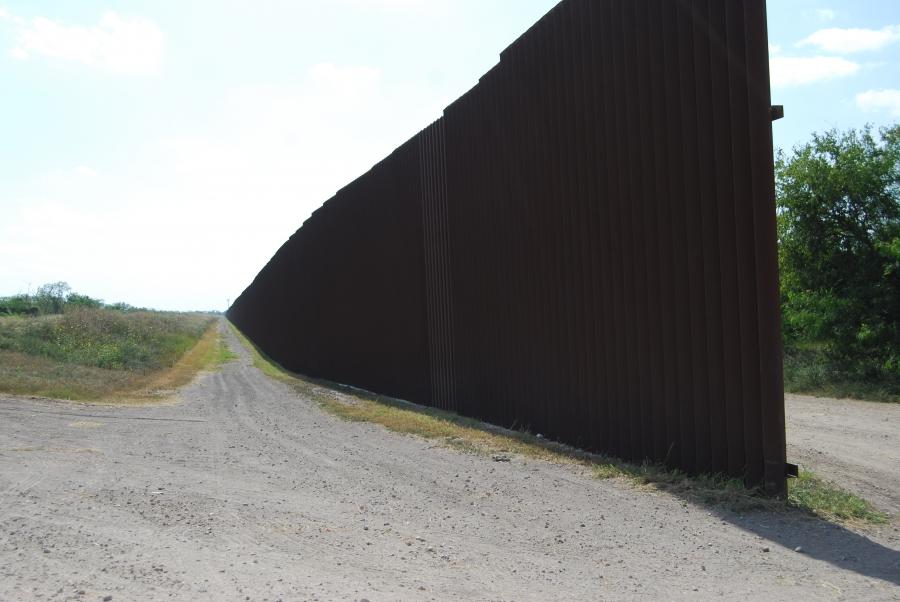 The 18-foot border wall in Hidalgo, Texas, starts and stops, with gaps, along the Rio Grande River.