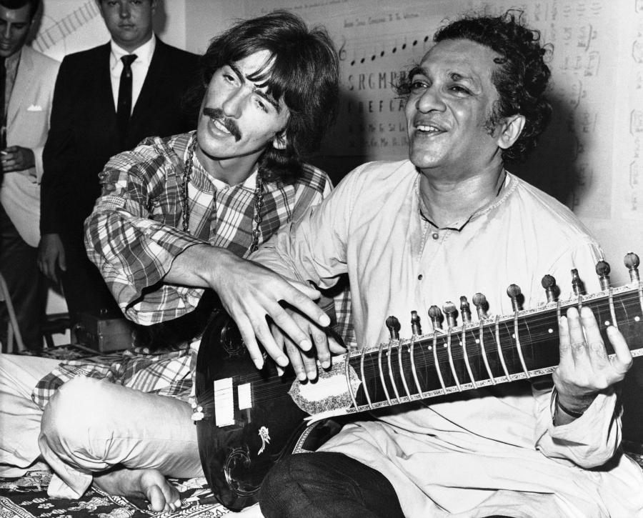 George Harrison of the Beatles sits cross-legged with his musical mentor, Ravi Shankar of India,