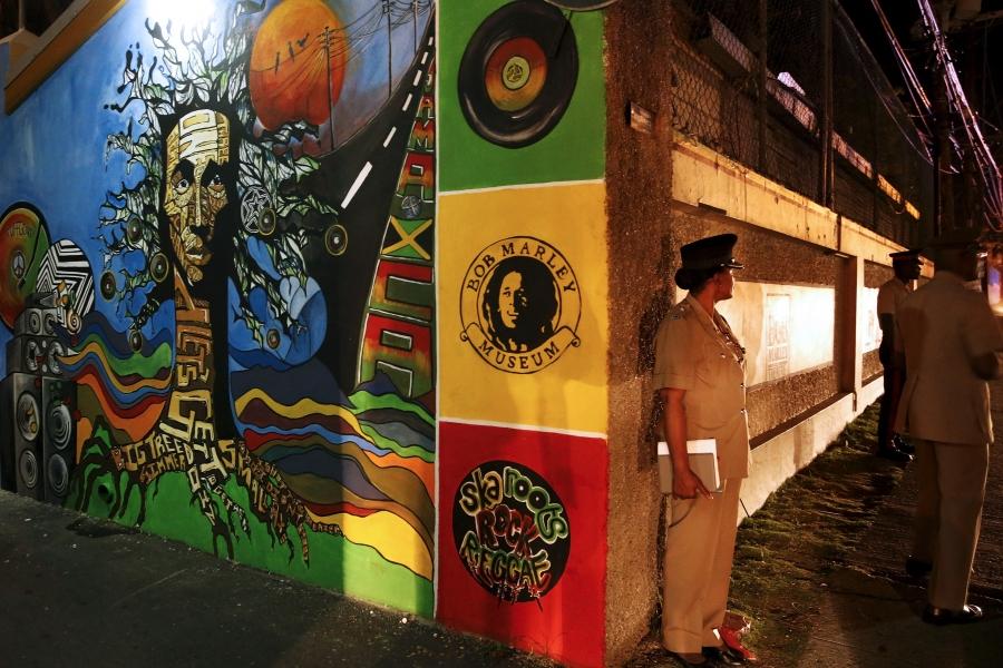 Police keep watch outside as US President Barack Obama gets a tour of the Bob Marley Museum in Kingston, Jamaica April 8, 2015.