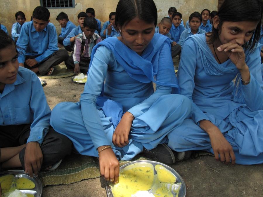Sumit (left) and Monit (right) are best friends, but they're from different castes.  Yet the two 12-year-olds regularly eat school lunch together, even from the same plate.  That's something that you might not have seen at this school in Haryana when Indi
