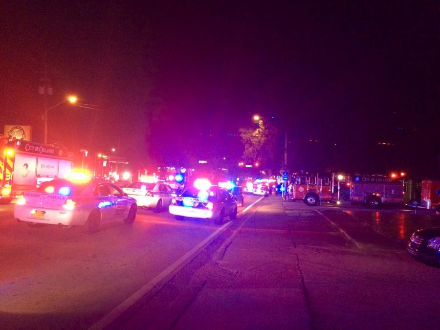 Police cars and fire trucks are seen outside the Pulse night club