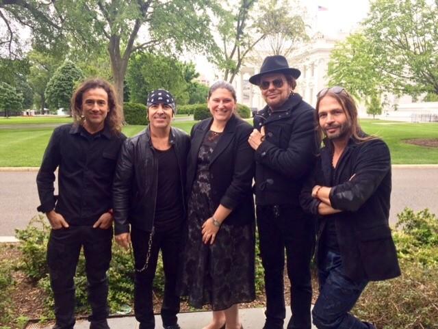 Gabriela Chojkier, Senior Director of Hispanic Media at the White House, poses with Latin rock band Mana