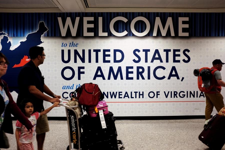 A family exits after clearing immigration and customs at Dulles International Airport