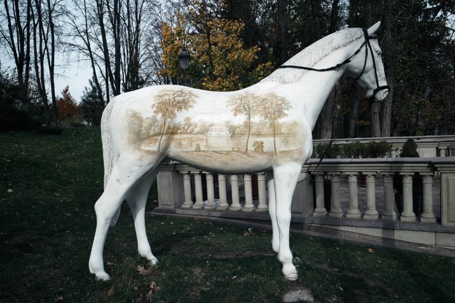 A life-size horse with aerograph on its side.