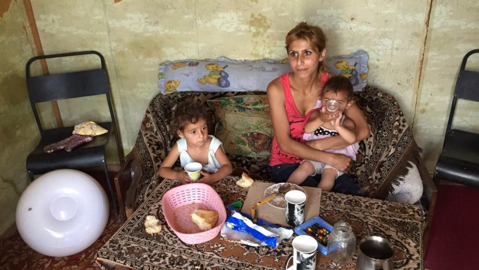 Melina fed her 2- and 3-year-old daughters in her domik in Armenia while her husband Artyom worked in Russia. He has since returned to be with his family but can’t find work.