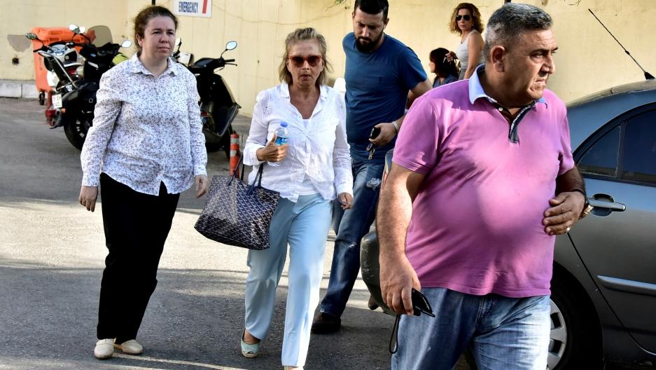Turkish journalist Nazli Ilicak (C), also a well-known commentator and former parliamentarian, is escorted by a police officer (R) and her relatives (L and rear) after being detained and brought to a hospital for a medical check in Bodrum, Turkey, July 26