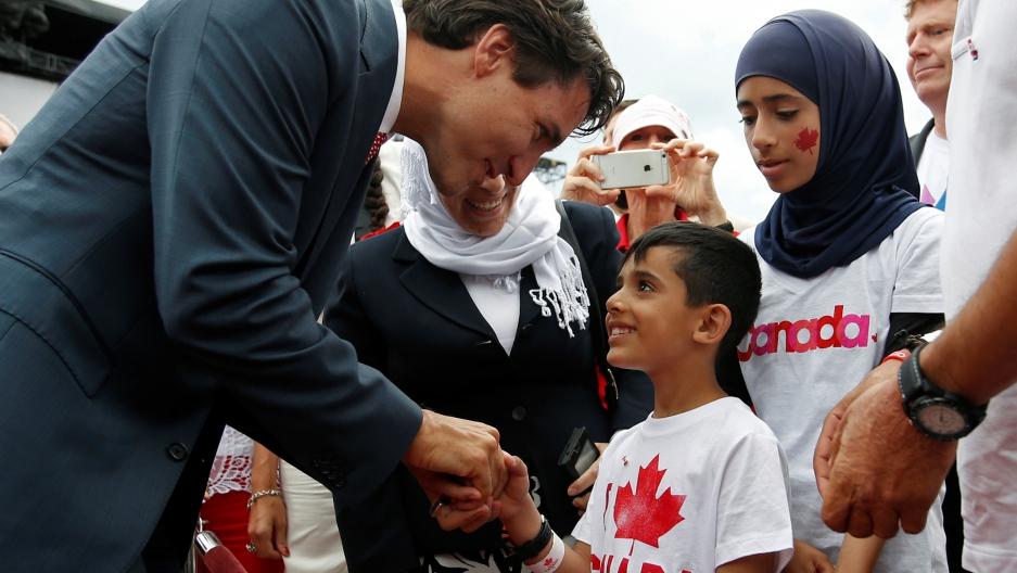 Canada's Prime Minister Justin Trudeau shakes hands with a Syrian refugee during Canada Day celebrations on Parliament Hill in Ottawa, Ontario, Canada, July 1, 2016. 