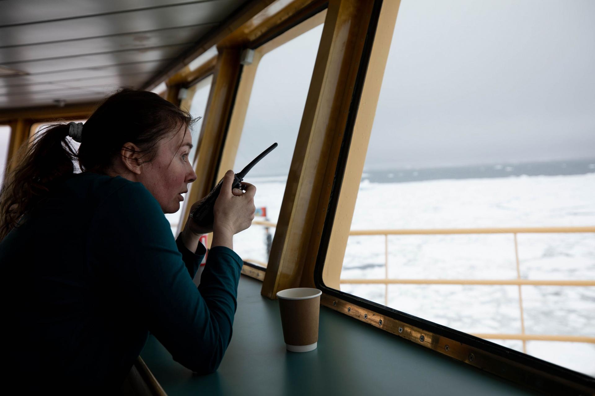 Researcher Anna Wåhlin is shown with a microphone looking out on the ocean.