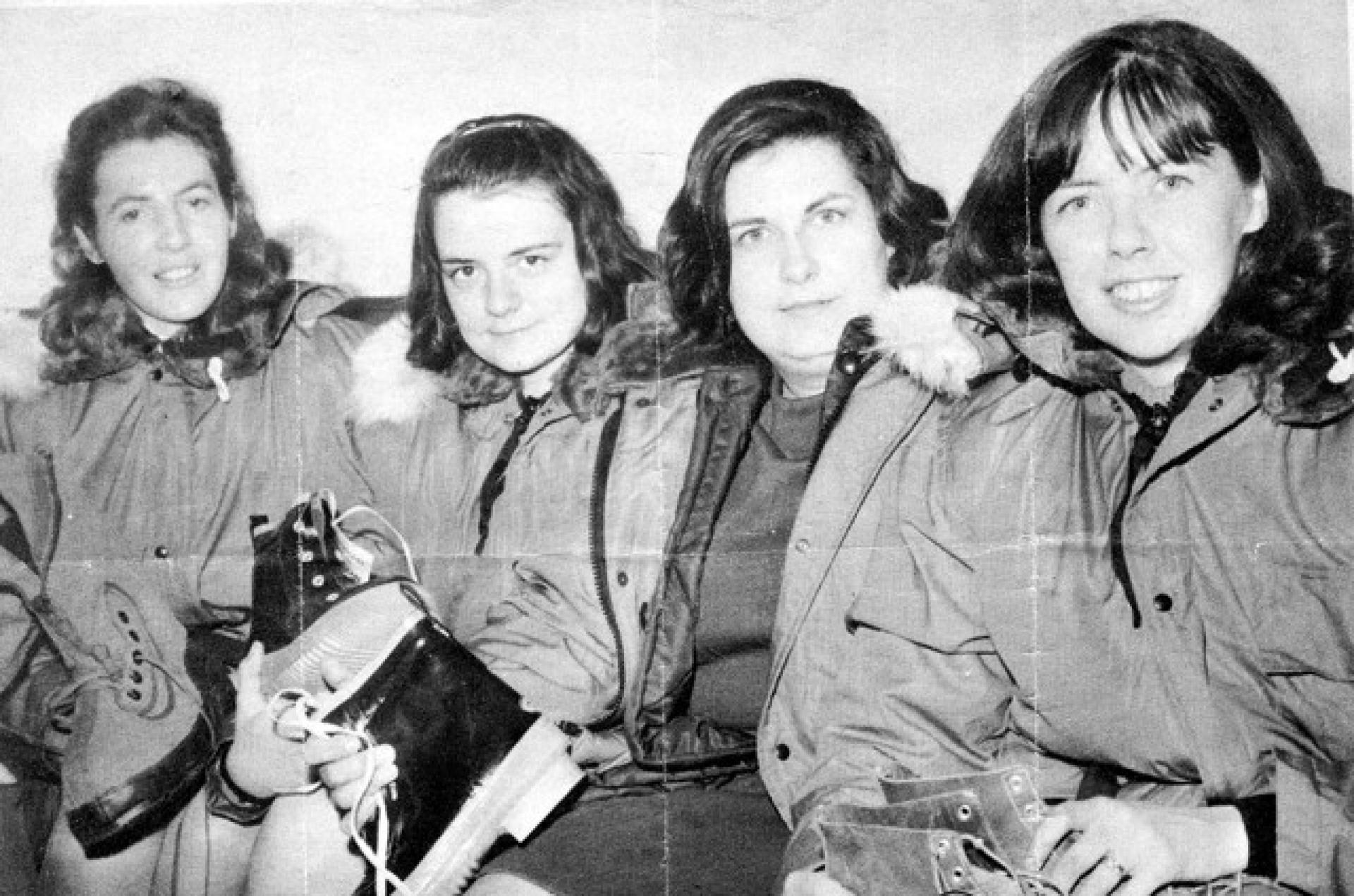 Four women pose for a photo in winter gear.