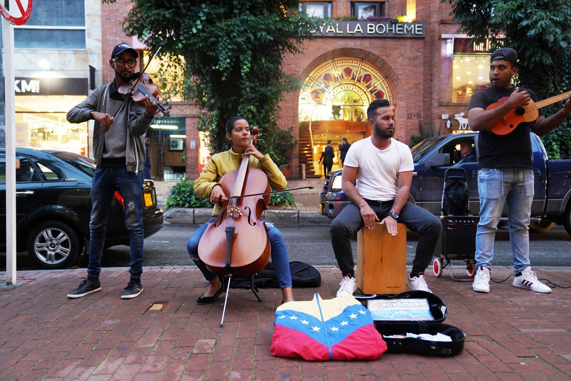 A group of musicians play music on the street. 