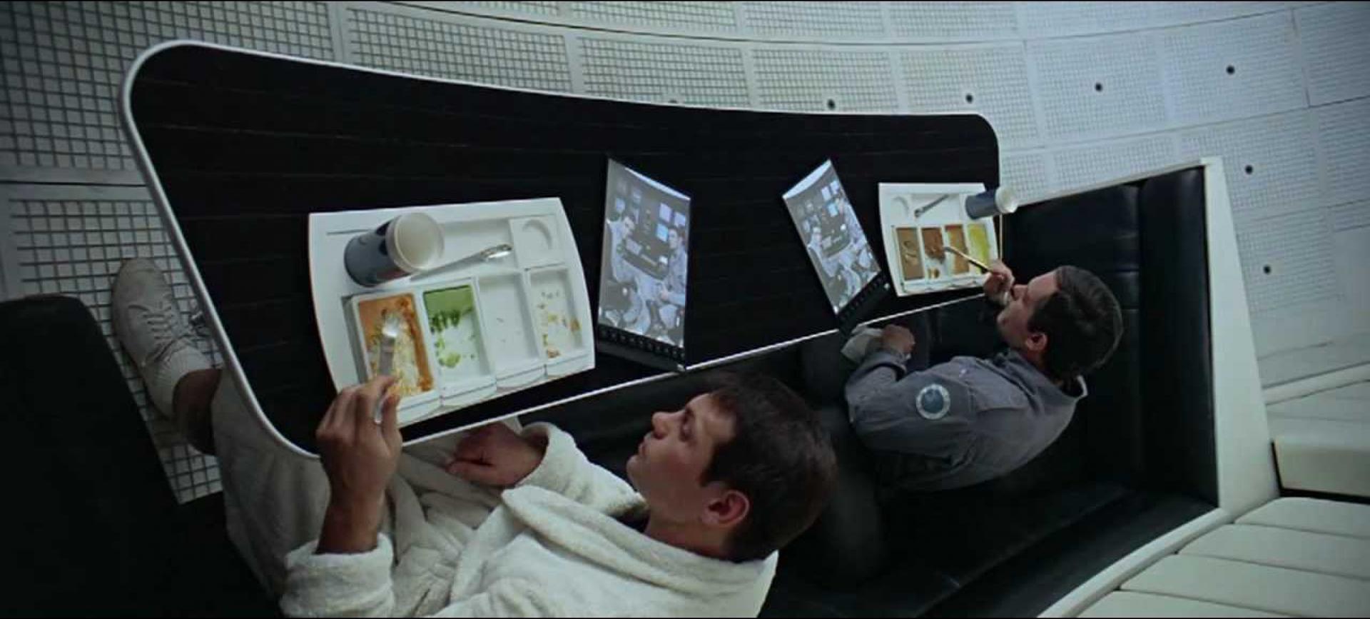 Dr. Francis Poole and Commander David Bowman watch a news segment about their mission on iPad-like screens in Stanley Kubrick’s “2001: A Space Odyssey.”