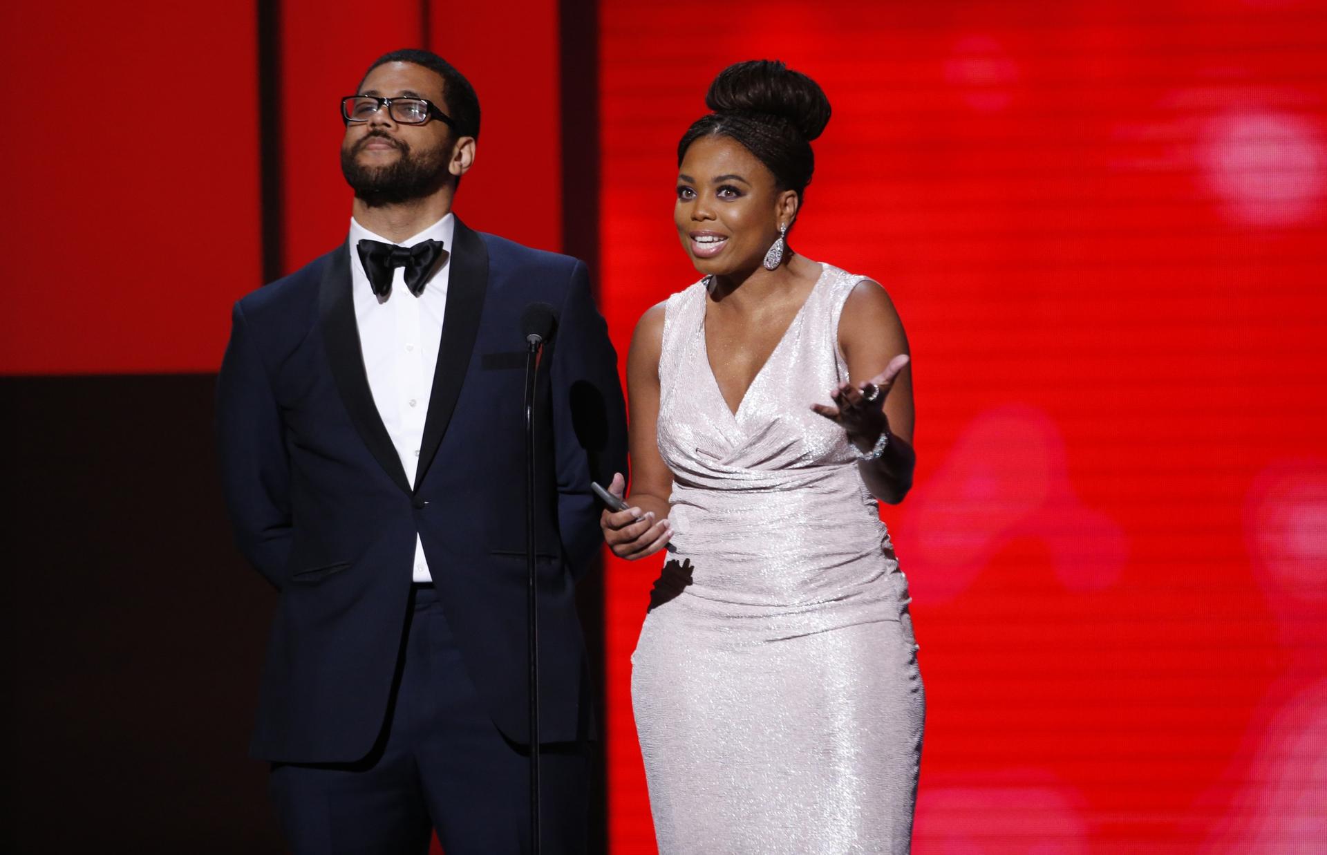 Presenters Jemele Hill and Michael Smith speak on stage at 49th NAACP Image Awards. 