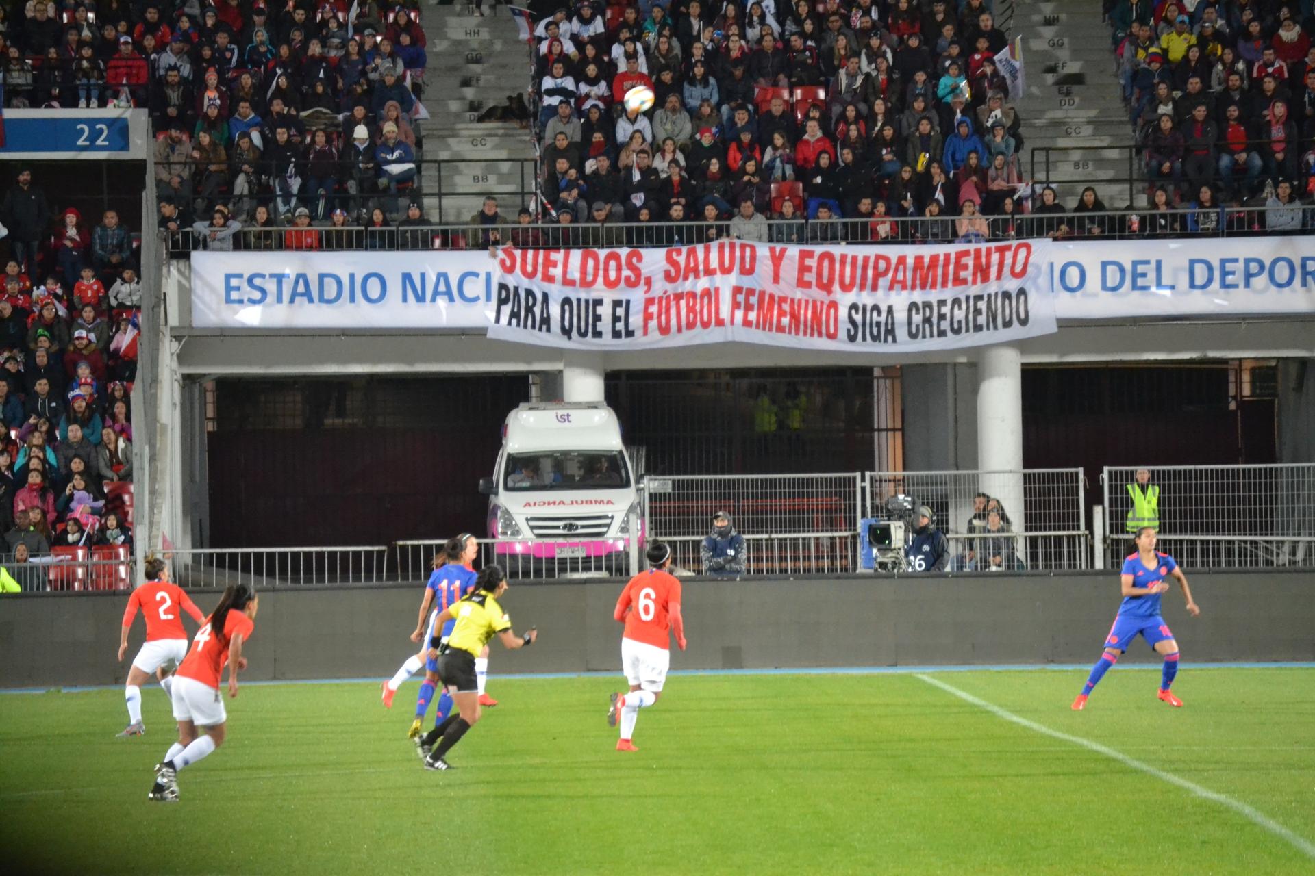 A sign on women's rights held in stadium during women's soccer match. 