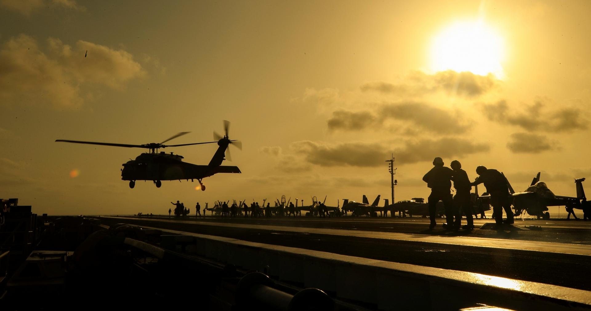 An MH-60S Seahawk helicopter lifts off the flight deck of the US Navy aircraft carrier USS Abraham Lincoln in the Arabian Sea, June 3, 2019.
