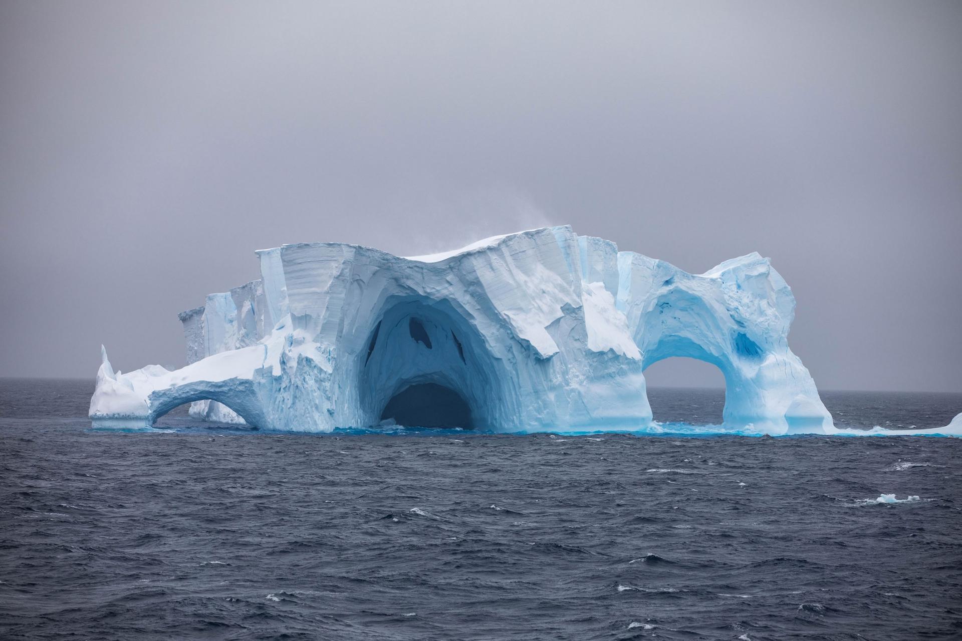 An iceberg has strange arch formations 