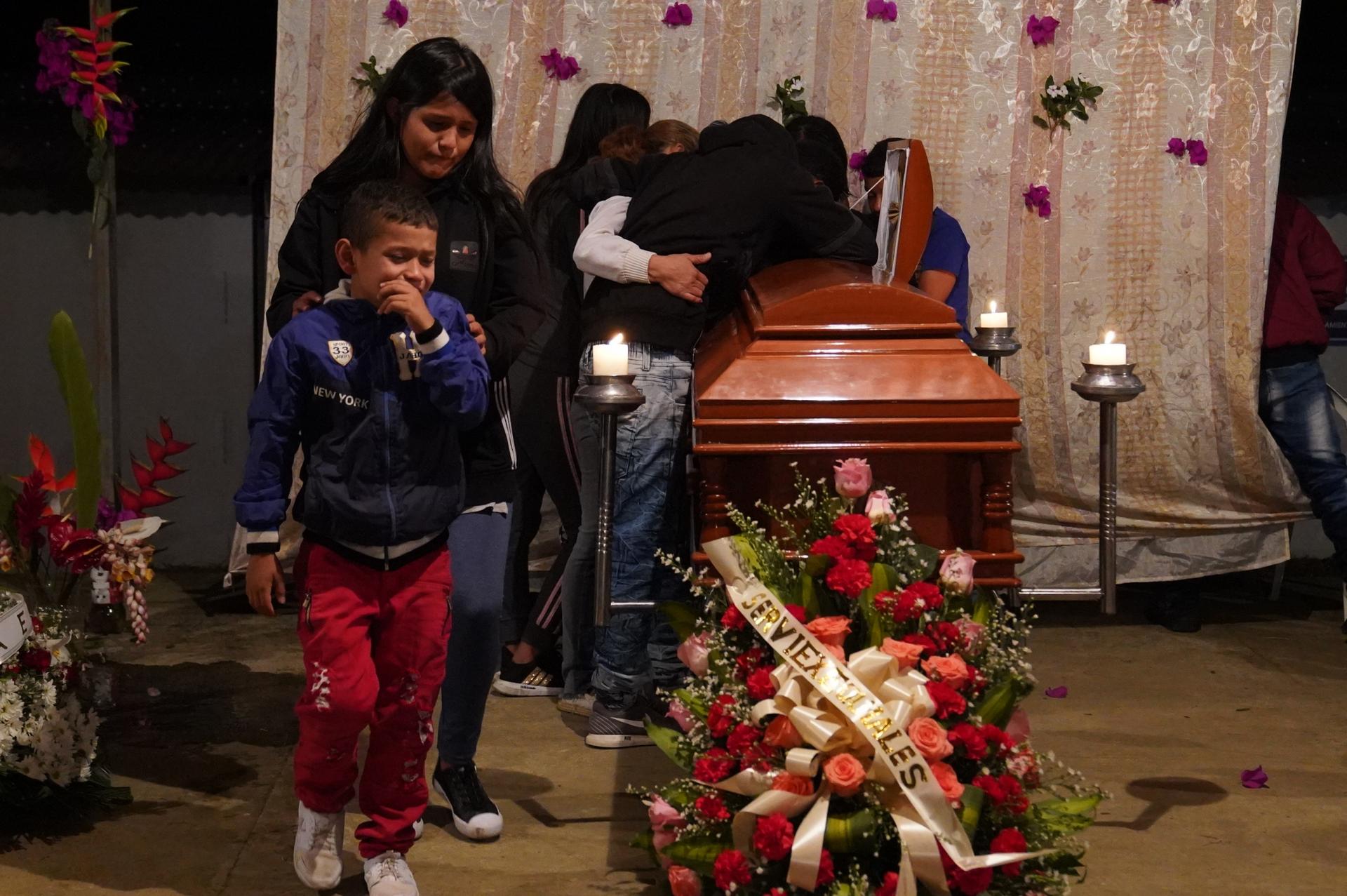 Family mourns and weeps over a coffin