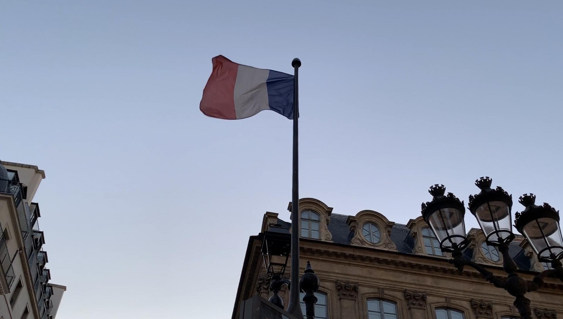 French flag waves at dusk