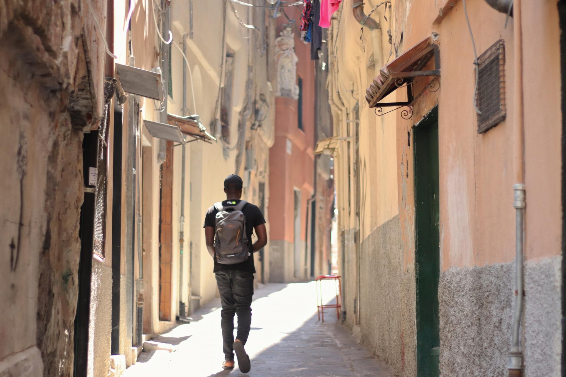 Moussa strolls through the center of Genoa.