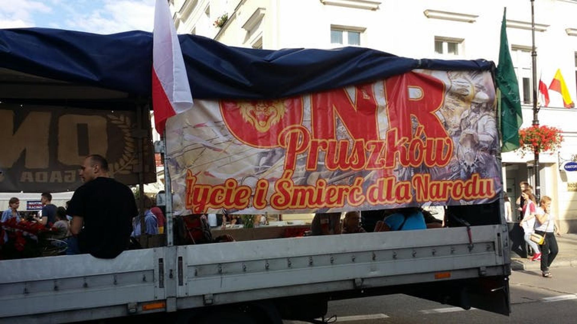 A truck with a sign on it written in Polish