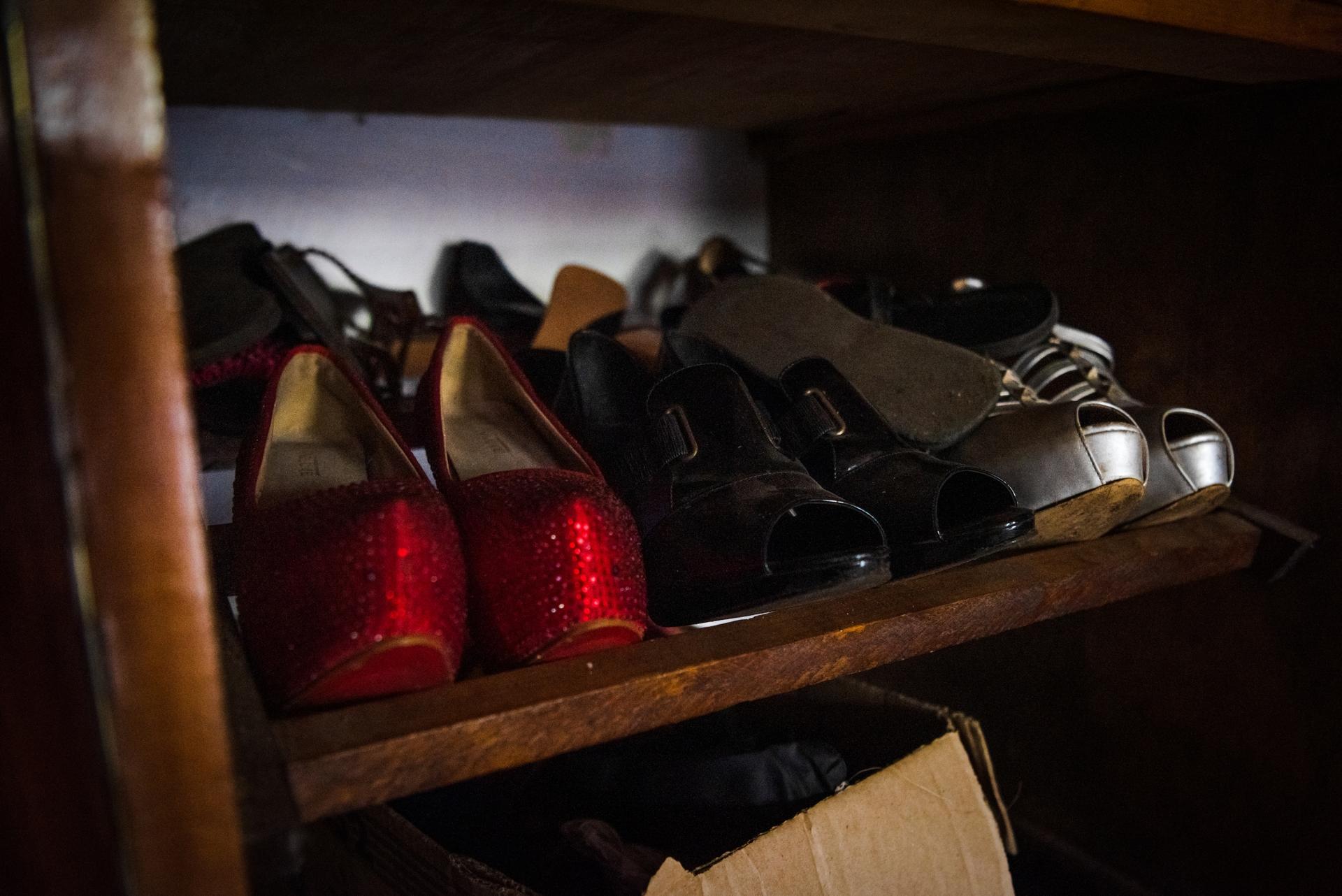 A row of high heeled shoes in red and black
