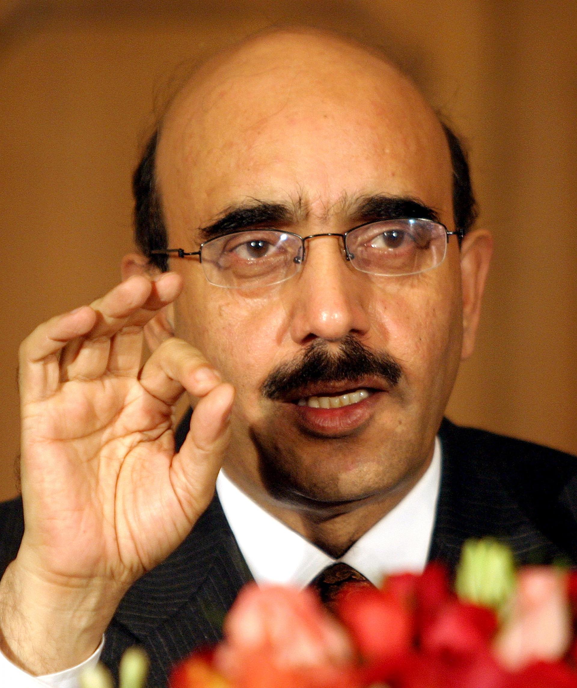 Sardar Masood Khan, president of the Pakistani side of divided Kashmir, gestures during a news conference at Pakistan's foreign ministry in Islamabad, December 23, 2004.