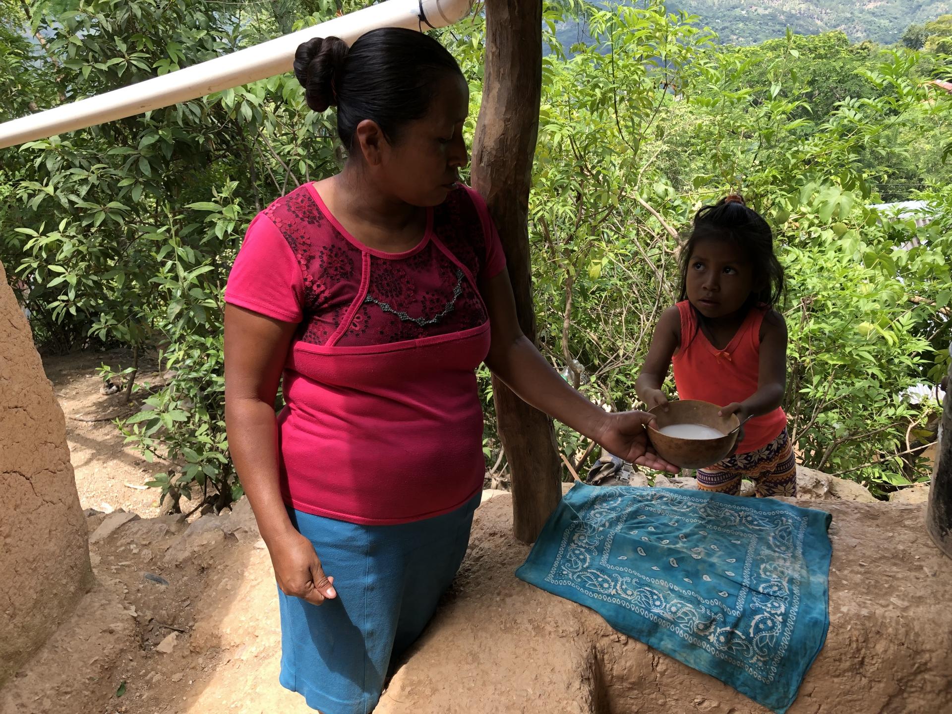 A Guatemalan mother prepares broth for her daughter, whom doctors say is malnourished. 