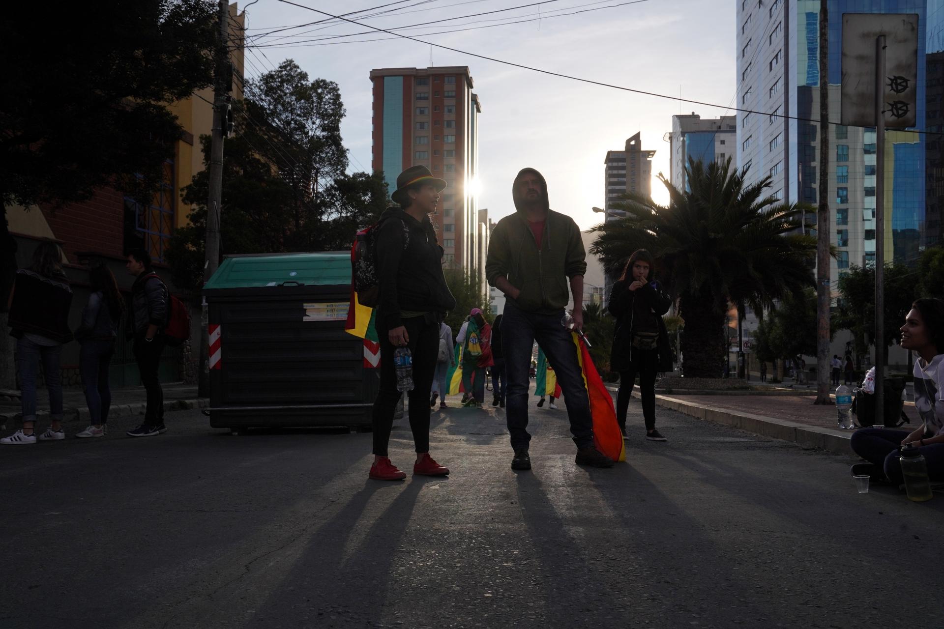 A group of young men blocks a road in Bolivia's capital city to protest the reelection of Bolivian President Evo Morales to his fourth term. Protesters claim he is leading Bolivia toward dictatorship. 