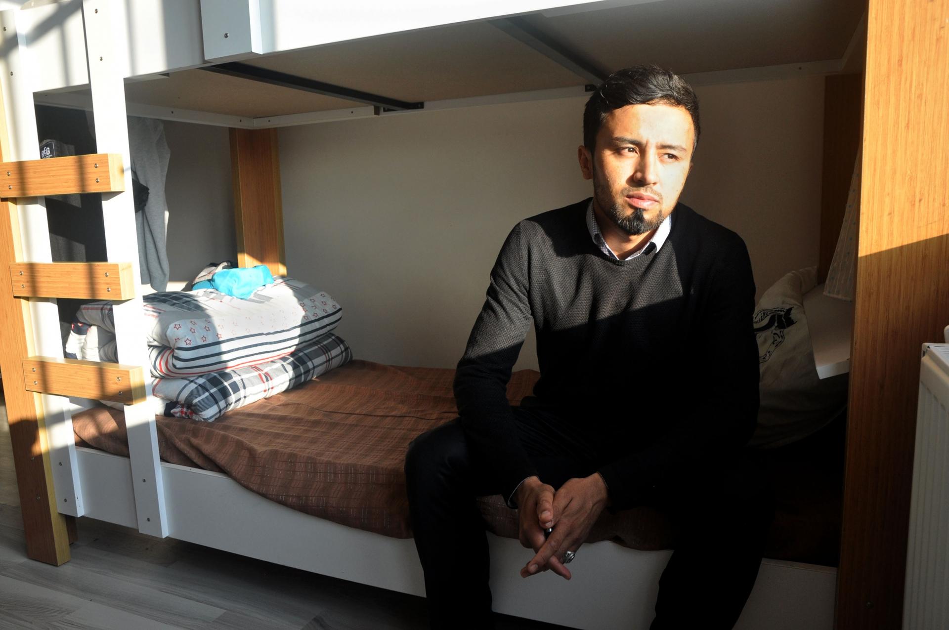 Mohammed Izatullah, 30, sits on a bunk bed in the dormitory. 