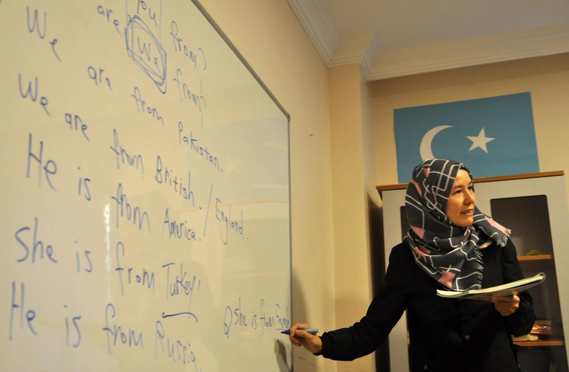 A teacher conducts an evening English class at Oku Uygur Bilig Yurdu, a school for Uighur children.