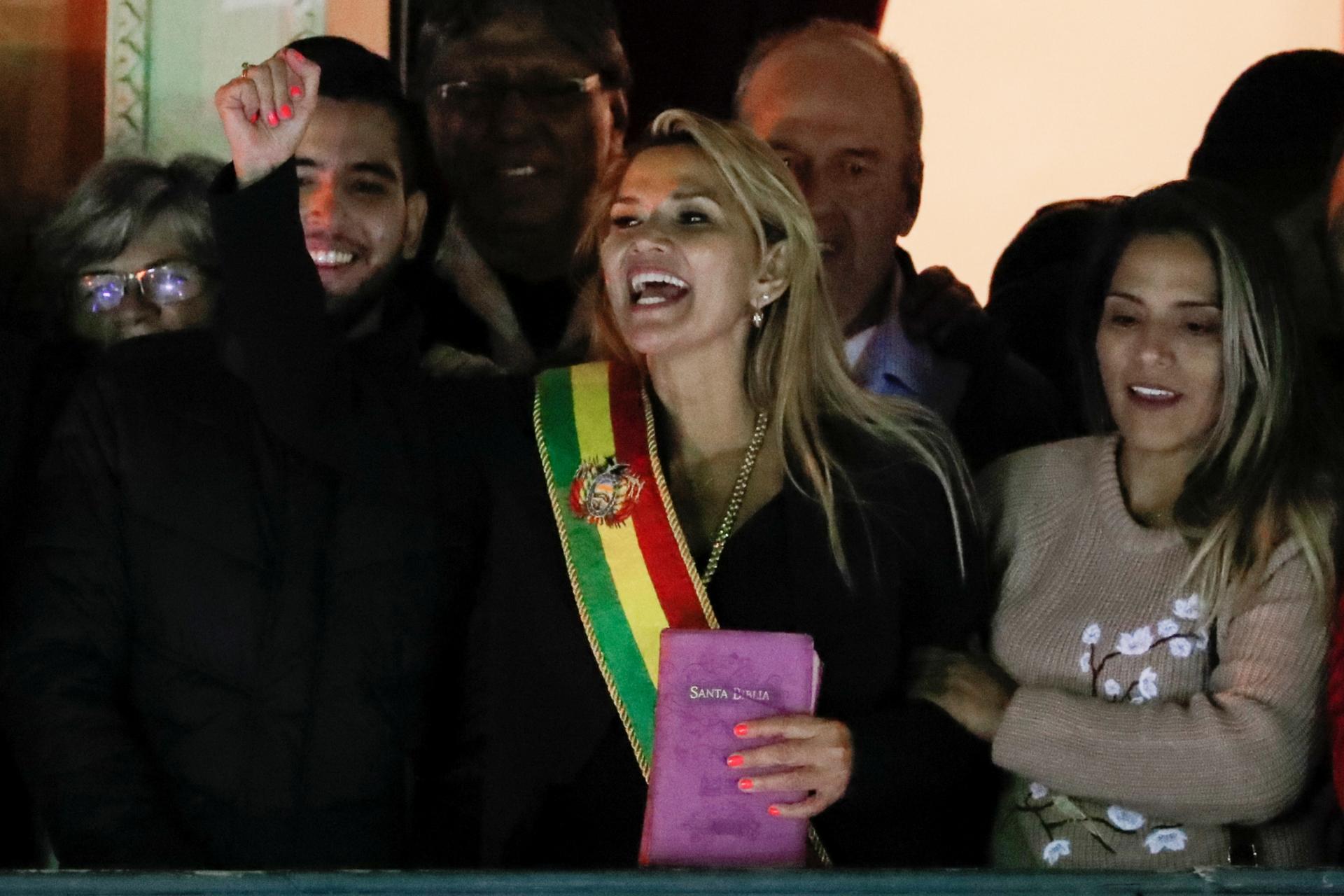 Bolivian Senator Jeanine Añez gestures after she declared herself as Interim President of Bolivia, at the balcony of the Presidential Palace, in La Paz, Bolivia, on Nov. 12, 2019.