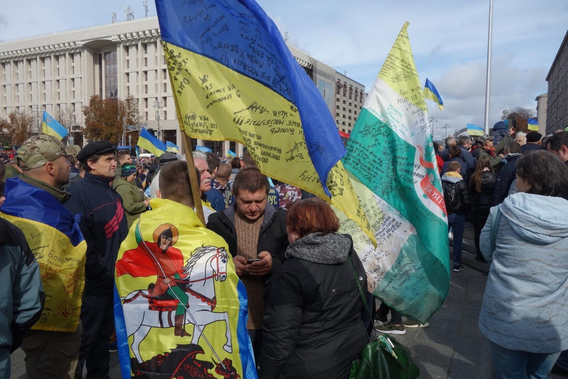 Protesters holding Ukrainian flags gather on Kyiv's Independence Square.