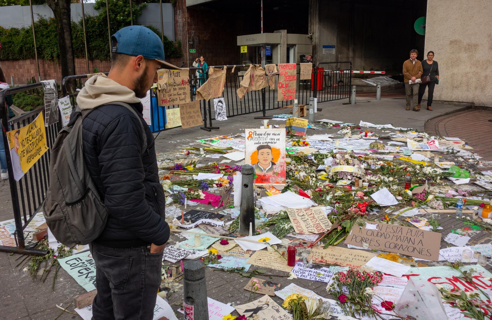 A young man pays tribute to a memorial for slain protester 