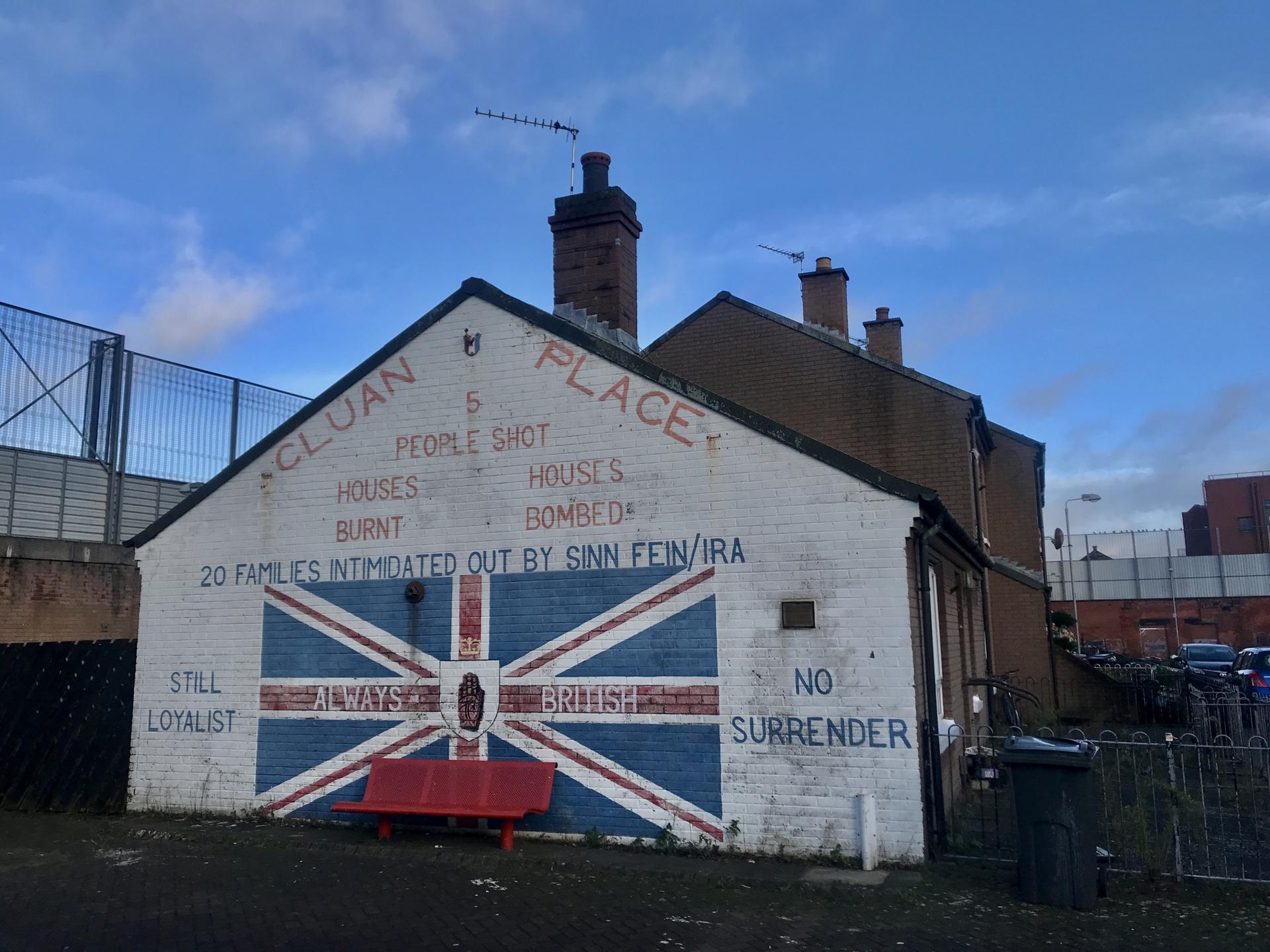 A side of a house is painting with British loyalist colors and message. 