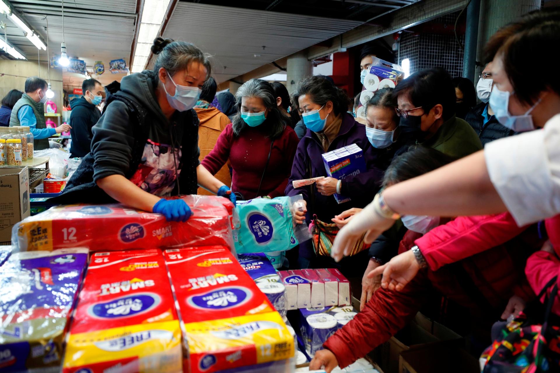 Customers pick paper products at a market, following the outbreak of COVID-19, in Hong Kong, China Feb. 11, 2020. 
