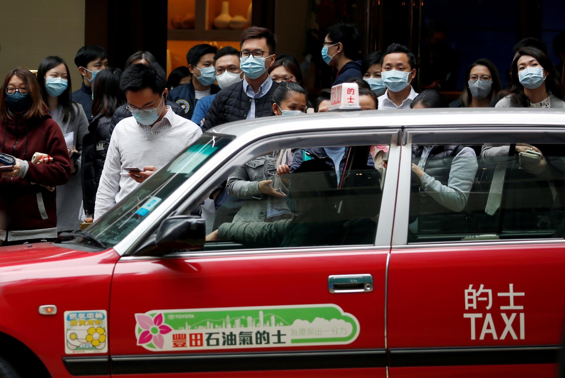 People wear masks on crowded street in Hong Kong