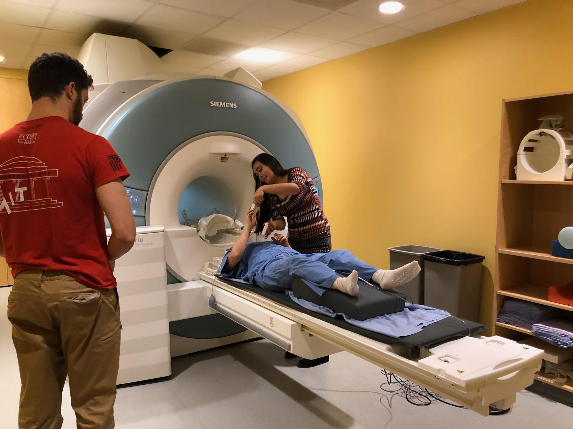 Two staff members are prepping Susanna Zaraysky ahead of her brain scan. 