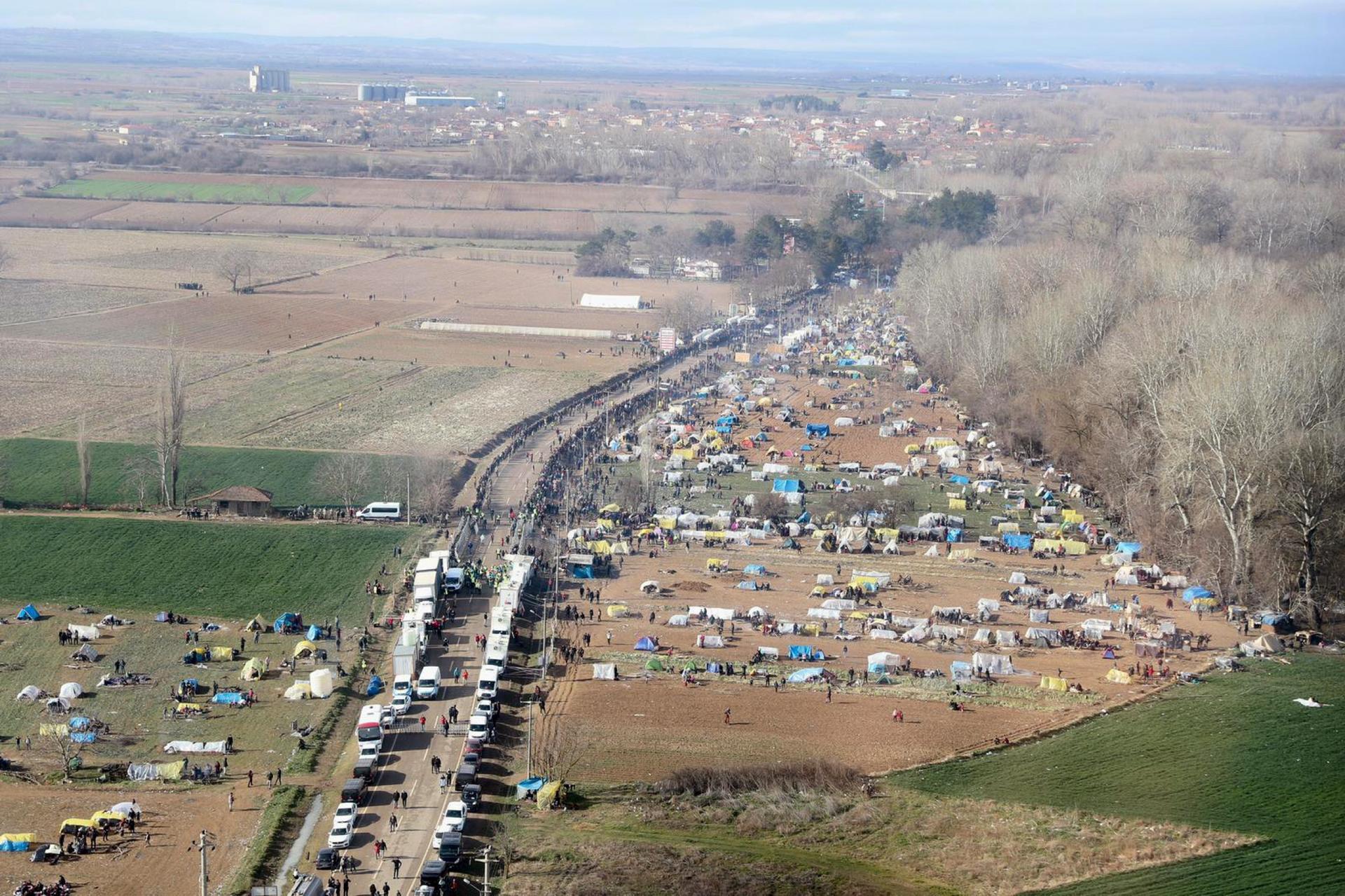 An aerial photo taken from the helicopter of Turkish Interior Minister Suleyman Soylu shows migrants waiting in line to receive food at Turkey's Pazarkule border crossing with Greece's Kastanies, near Edirne in Turkey, on March 5, 2020.