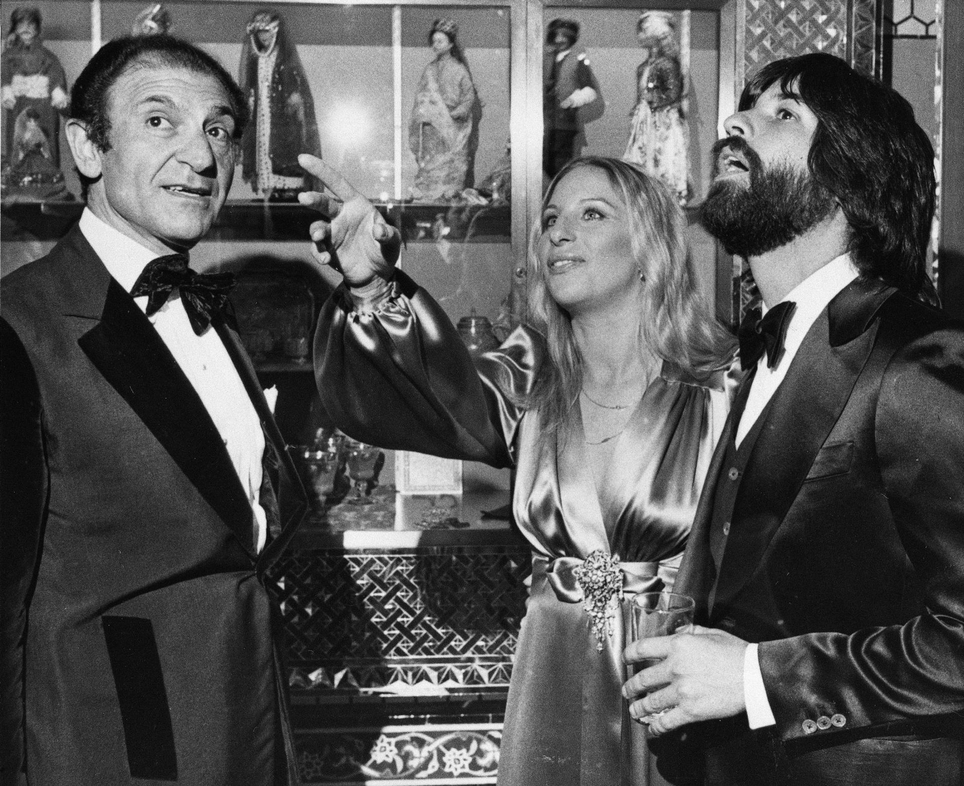 Iran's former Ambassador Ardeshir Zahedi, left, talks with actress Barbra Streisand is shown looking up and pointing.